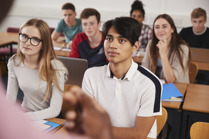 11th grade students completing free, printable 11th grade writing prompts for high school.