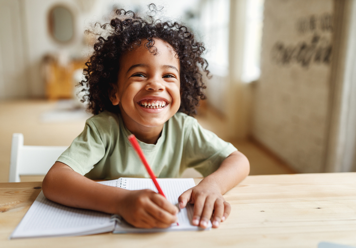 Preschooler tracing letters on printable pdf worksheet